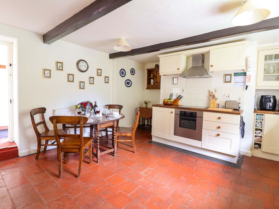 A kitchen with a table and chairs at Penymaes Bronygarth near Chirk