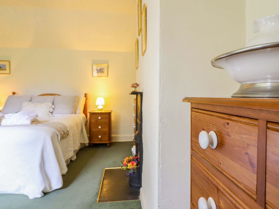 A bedroom with a bed and nightstand at Penymaes Bronygarth near Chirk