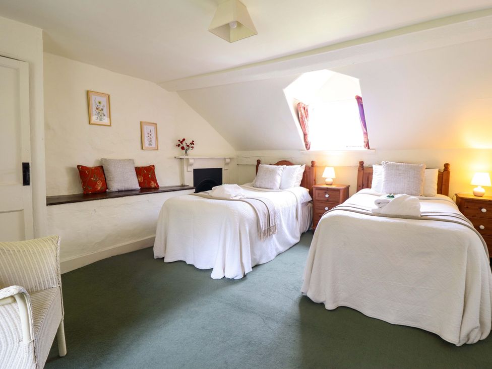 A bedroom with two beds and a window at Penymaes Bronygarth near Chirk