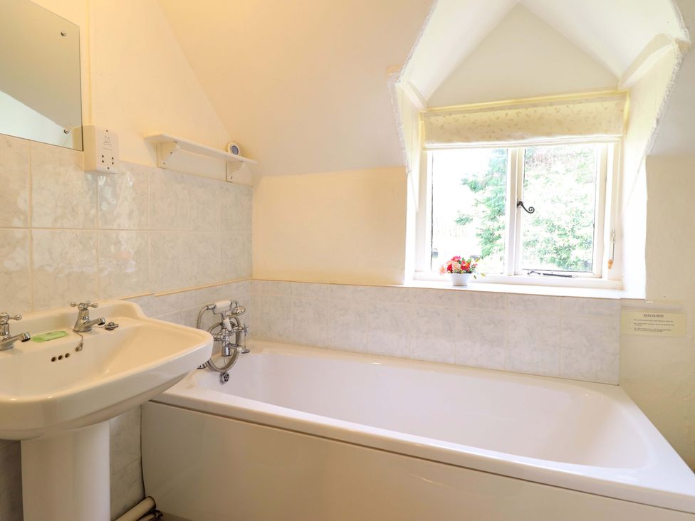 A bathroom with a bathtub and sink at Penymaes Bronygarth near Chirk