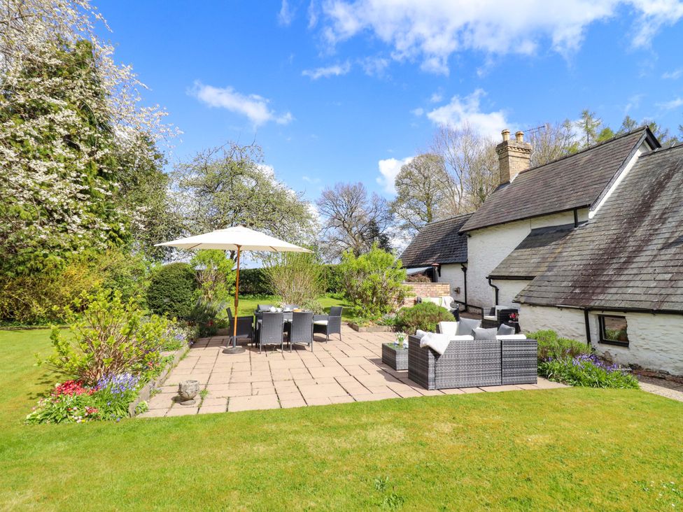 A garden with a patio, furniture and plants at Penymaes Bronygarth near Chirk