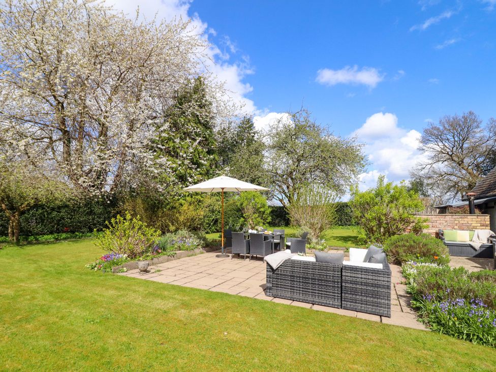 A garden with outdoor furniture and trees at Penymaes in Bronygarth near Chirk