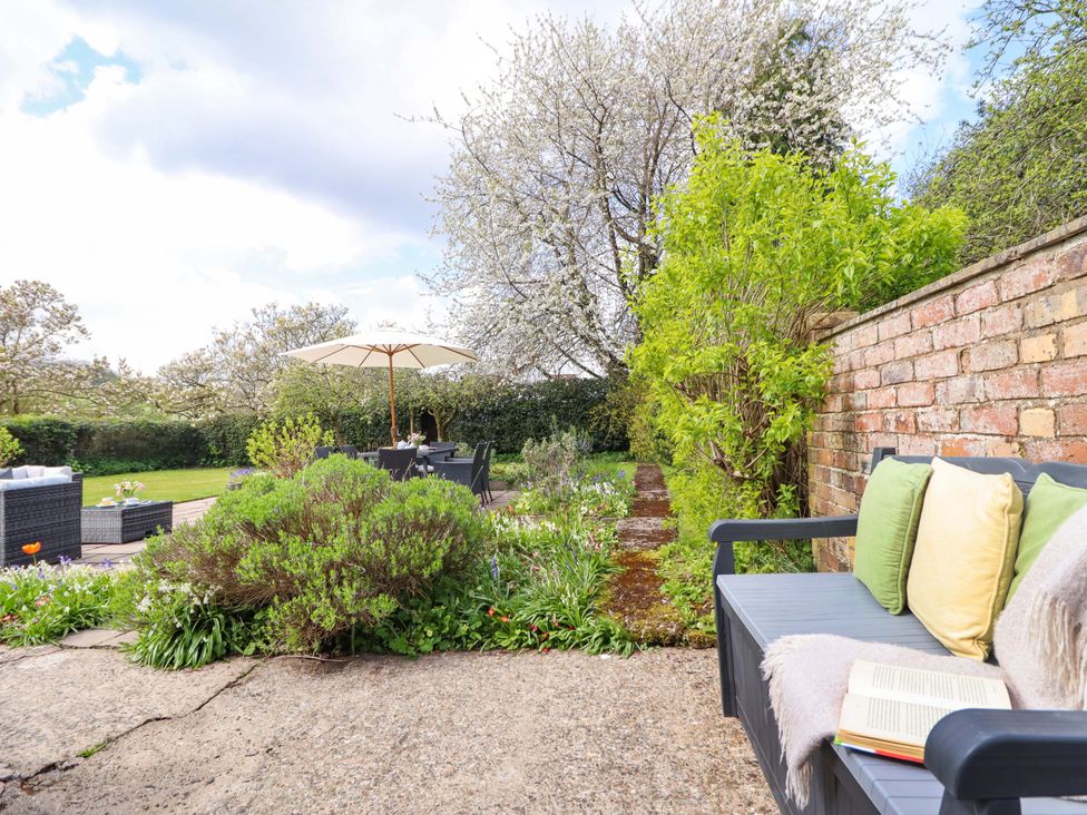 A garden with patio furniture and plants at Penymaes Bronygarth near Chirk
