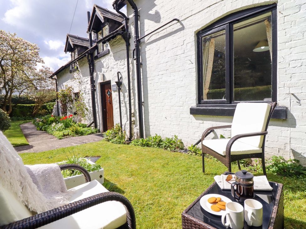 A garden with chairs and coffee at Penymaes Bronygarth near Chirk