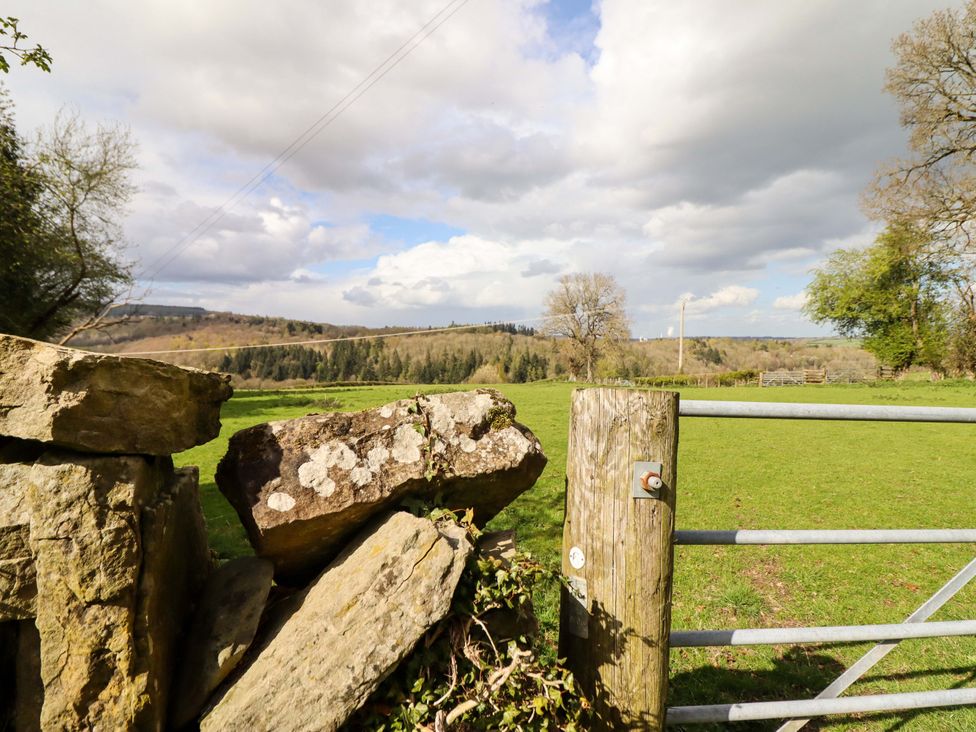 An outdoor view featuring a gate and stone wall at Penymaes Bronygarth near Chirk