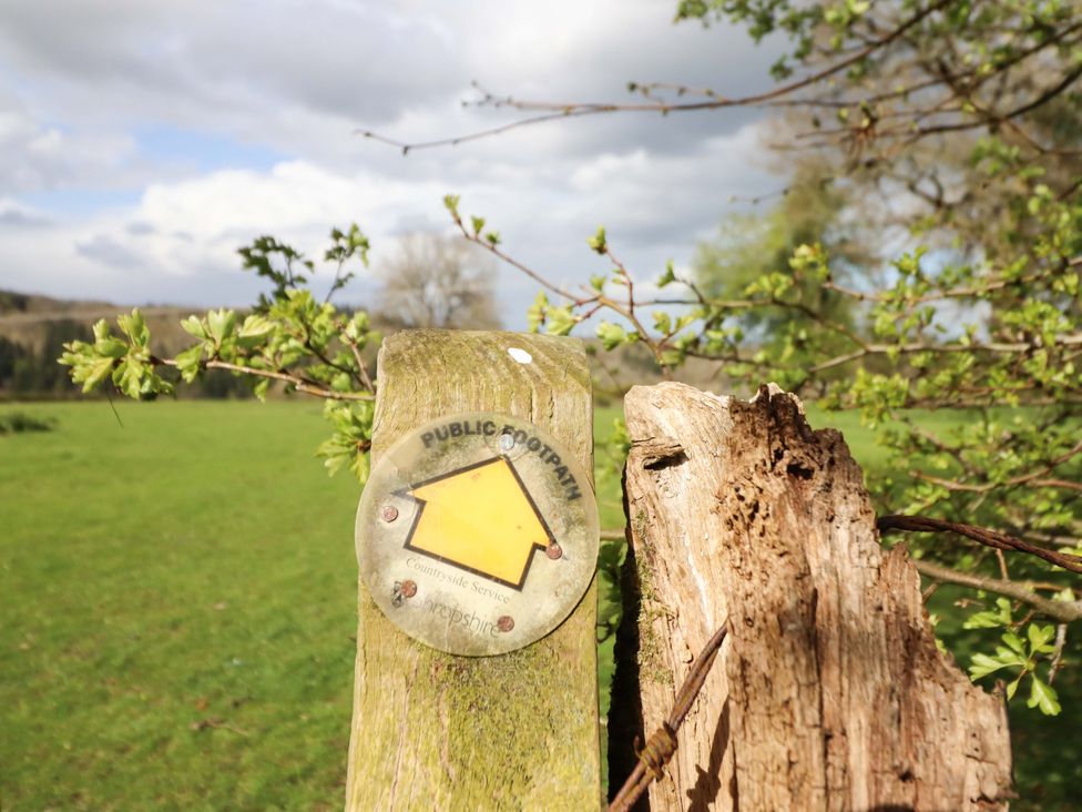 A sign indicating public footpath by wooden post in a field near Bronygarth near Chirk