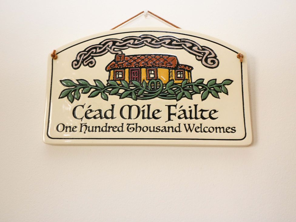 A sign with a house illustration and text reading Céad Míle Fáilte at No. 4 Lansdowne Village, Kenmare, The Ring of Kerry, County Kerry