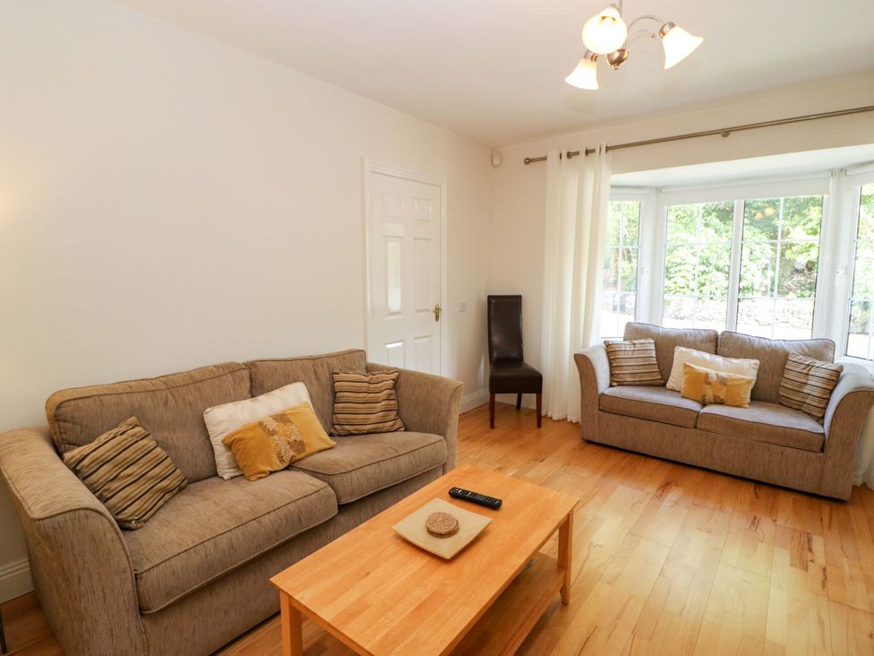 A living room with sofas and a coffee table at No. 4 Lansdowne Village, Kenmare, The Ring of Kerry, County Kerry
