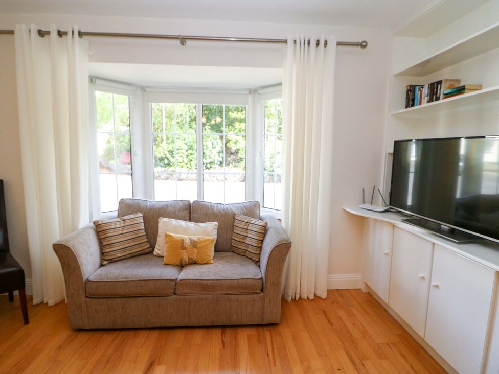 A living room with a sofa and television at No. 4 Lansdowne Village, Kenmare, The Ring of Kerry, County Kerry