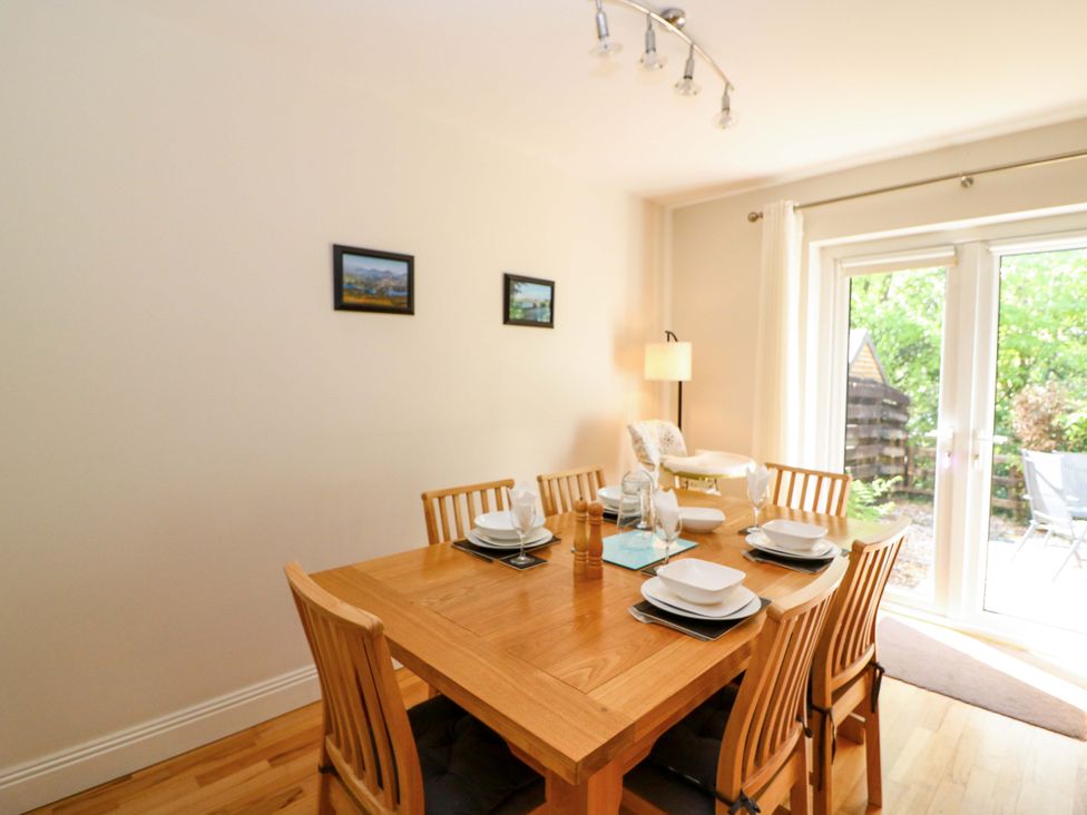 A dining room with a table set for meals at No. 4 Lansdowne Village in Kenmare, The Ring of Kerry, County Kerry