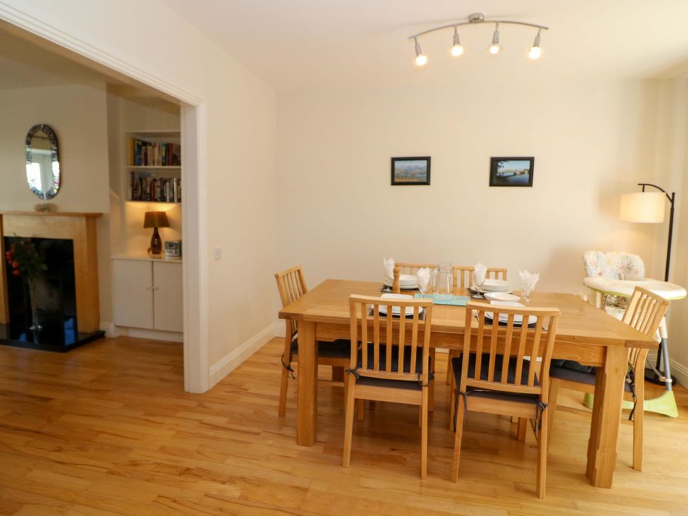 A dining room with a wooden table and chairs at No. 4 Lansdowne Village, Kenmare, The Ring of Kerry, County Kerry