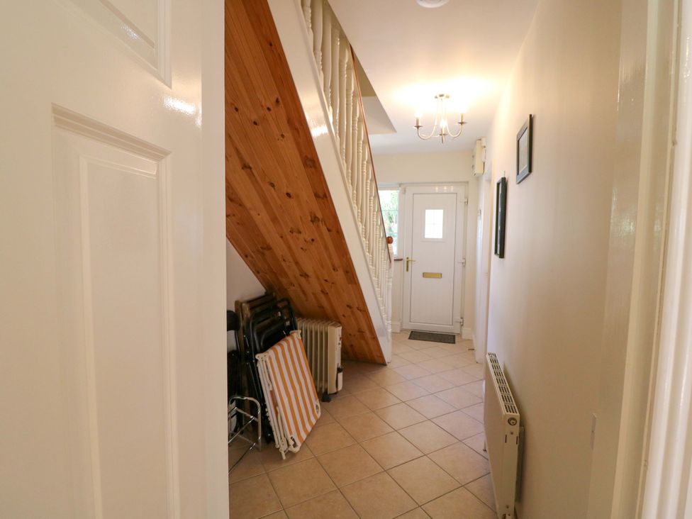 A hallway with a staircase and a door at No. 4 Lansdowne Village, Kenmare, The Ring of Kerry, County Kerry