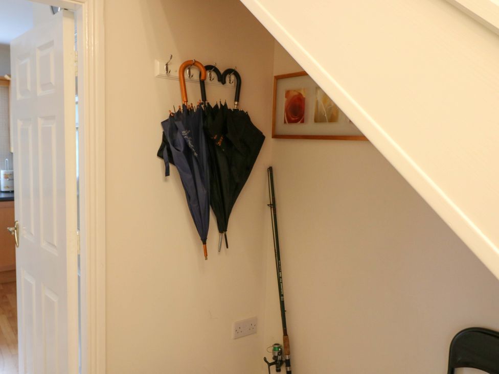 A hallway with umbrellas hanging on a wall at No. 4 Lansdowne Village, Kenmare, The Ring of Kerry, County Kerry