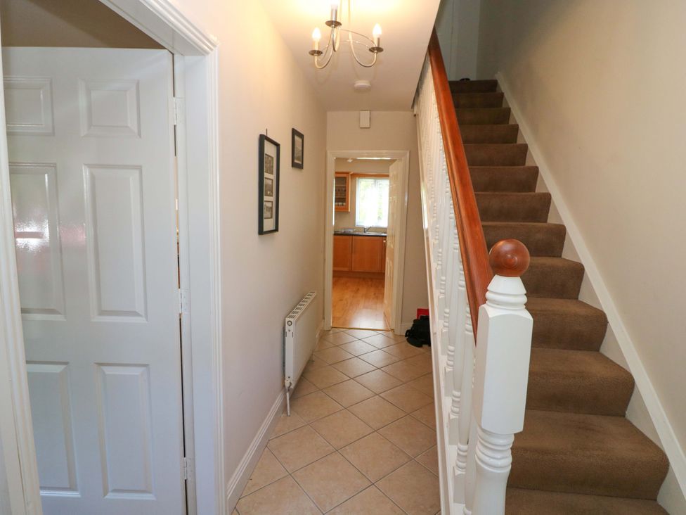 A hallway with stairs and door leading to kitchen at No. 4 Lansdowne Village, Kenmare, The Ring of Kerry, County Kerry