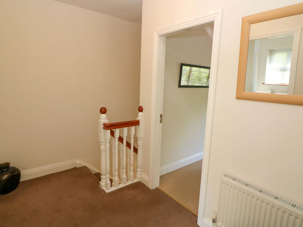 A hallway with a staircase and a door at No. 4 Lansdowne Village, Kenmare, The Ring of Kerry, County Kerry