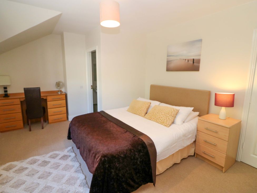 A bedroom with a bed and desk at No. 4 Lansdowne Village, Kenmare, The Ring of Kerry, County Kerry