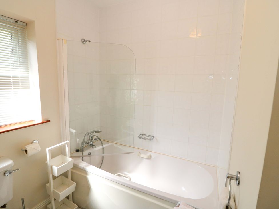 A bathroom with a bathtub and shower at No. 4 Lansdowne Village, Kenmare, The Ring of Kerry, County Kerry
