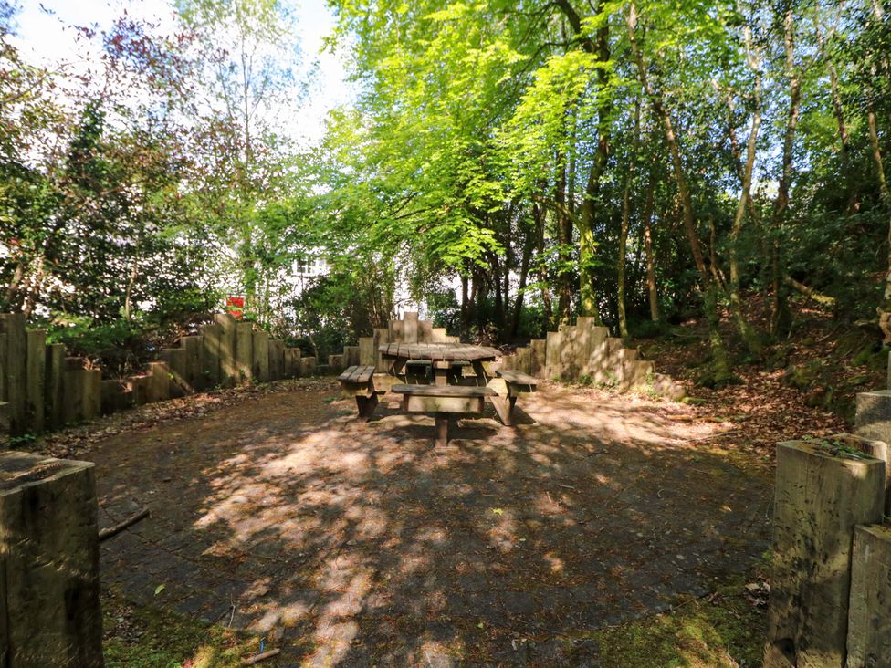 A garden area with a table and benches surrounded by trees at No. 4 Lansdowne Village, Kenmare, The Ring of Kerry, County Kerry