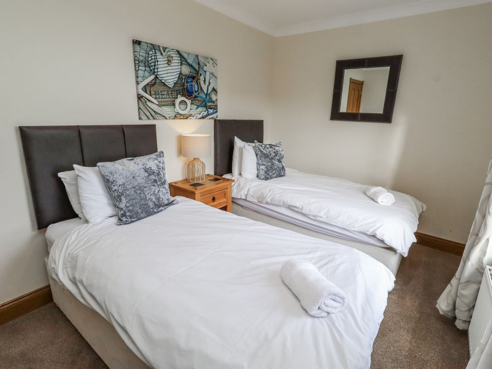 A bedroom with two single beds at Grey Croft in Embleton