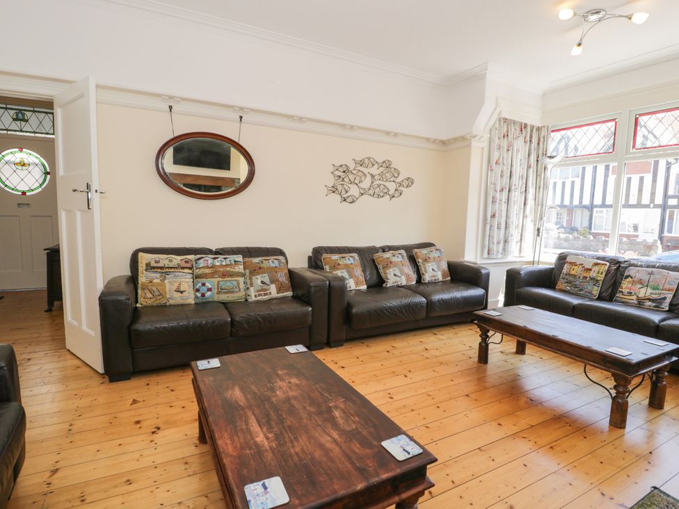A living room with leather sofas and a coffee table at Meadway House in Rhos-on-Sea