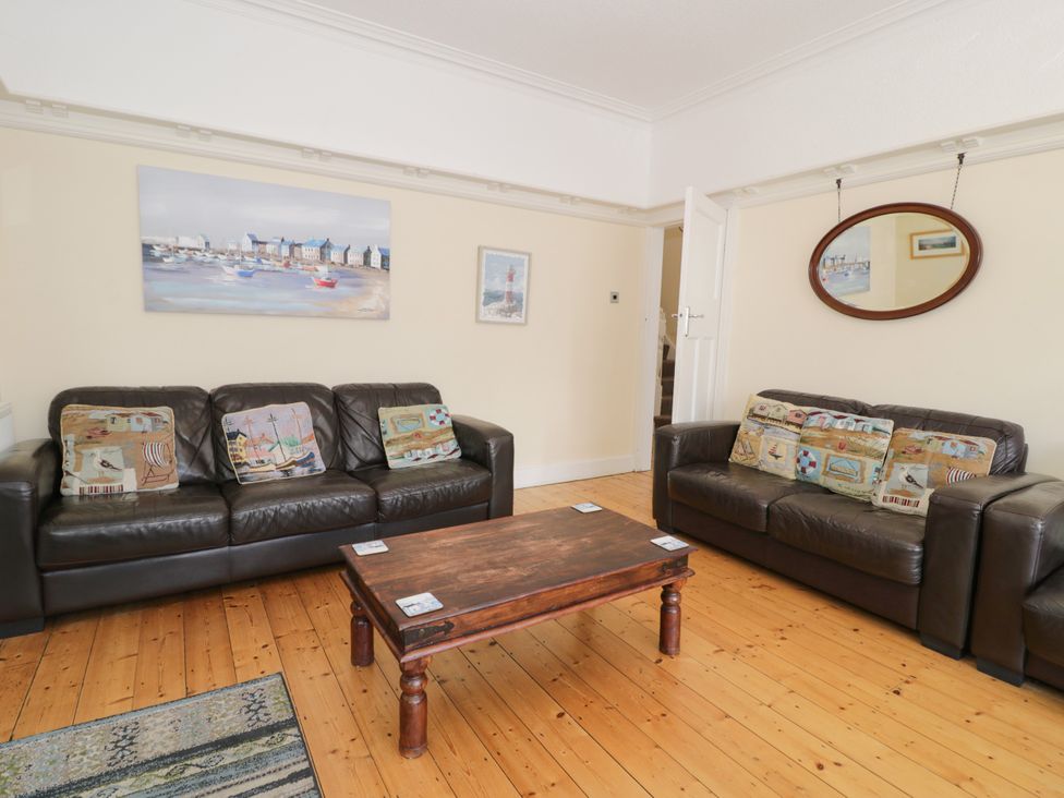 A living room with sofas and a coffee table at Meadway House in Rhos-on-Sea
