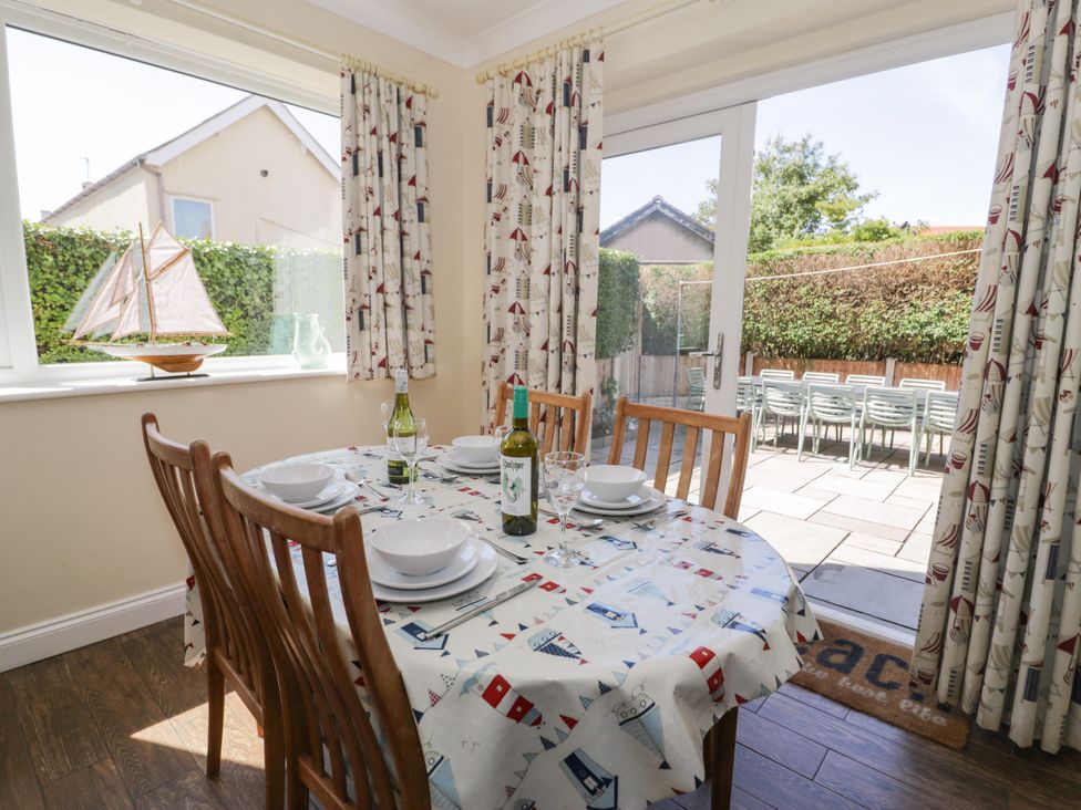 A dining room with a table set for a meal at Meadway House in Rhos-on-Sea