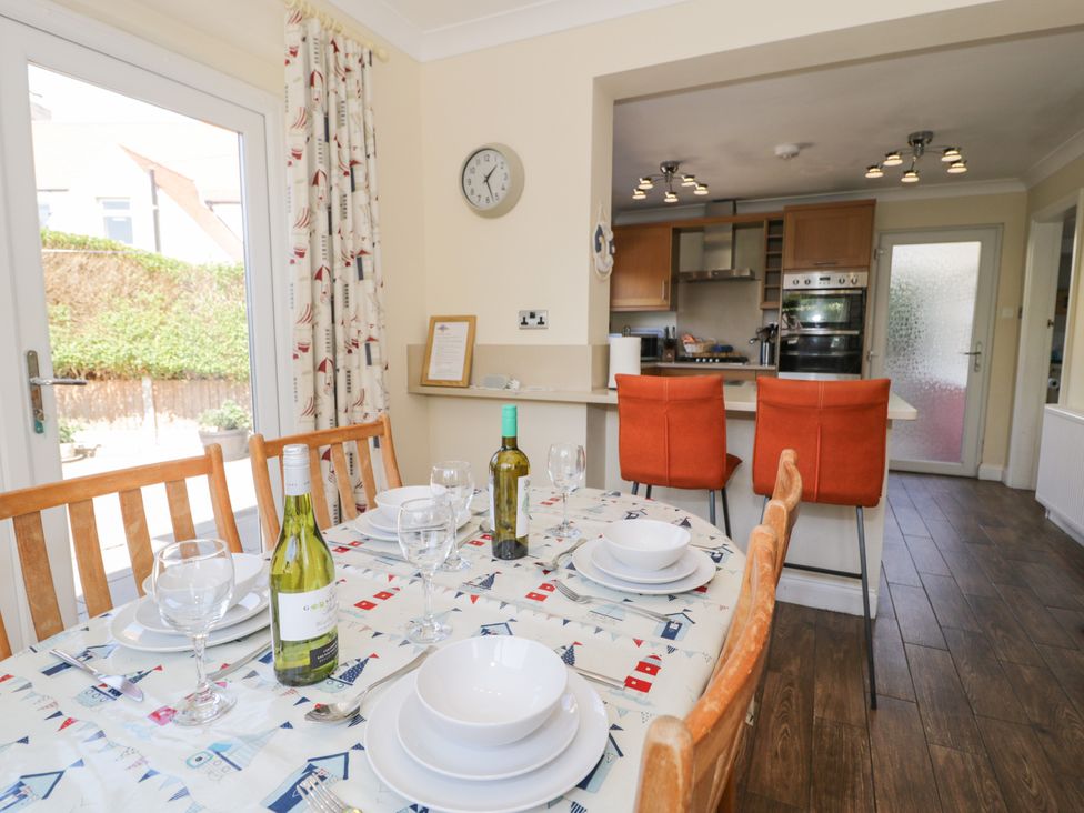 A dining room with a table set for meals at Meadway House Rhos-on-Sea