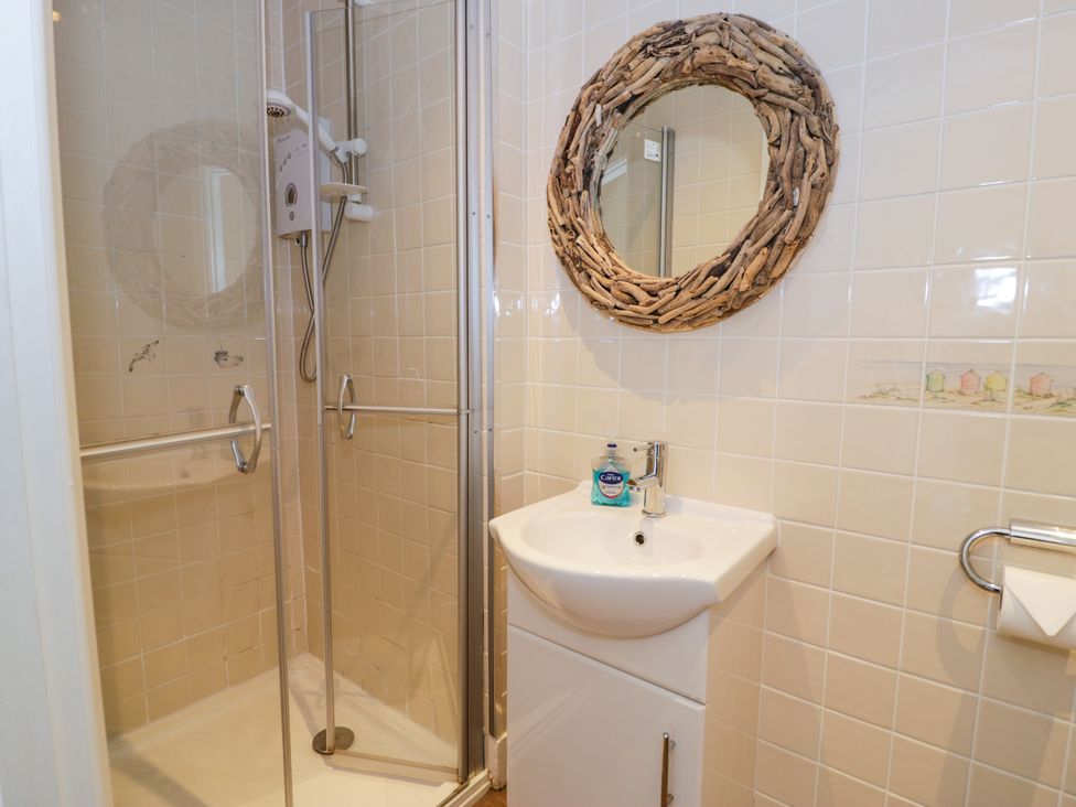 A bathroom with a shower and wash basin at Meadway House Rhos-on-Sea