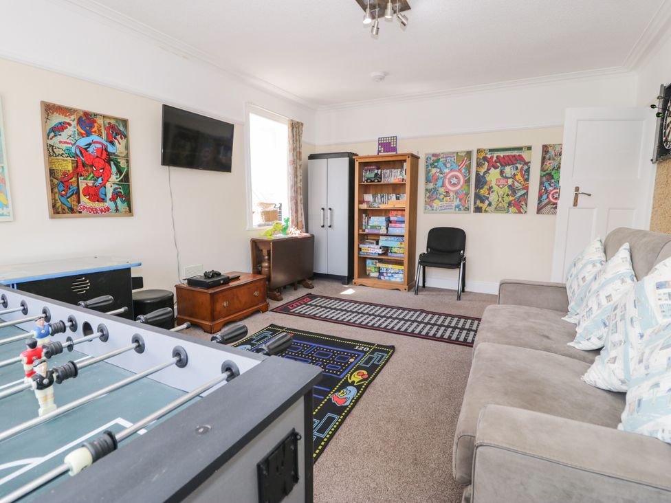 A snug with a foosball table and a television at Meadway House in Rhos-on-Sea