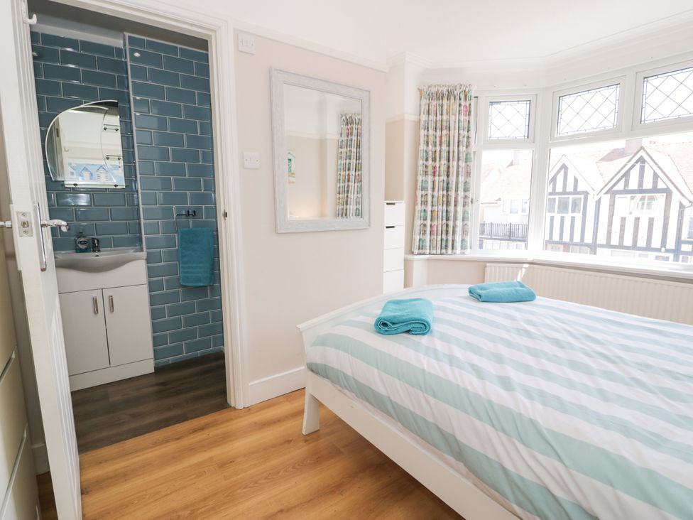 A bedroom with a bed and attached bathroom at Meadway House in Rhos-on-Sea