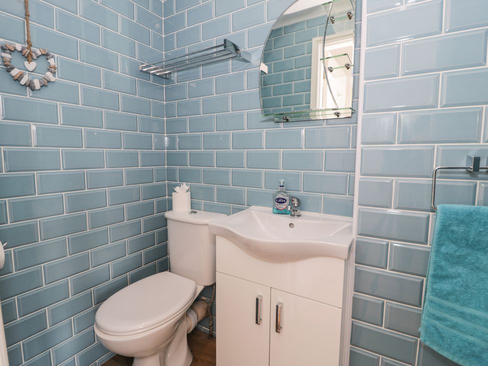 A bathroom with a sink and toilet at Meadway House in Rhos-on-Sea