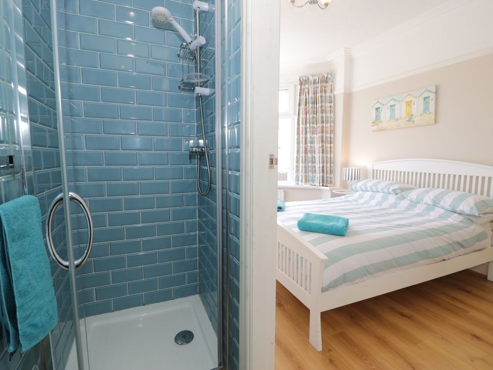 A bedroom with a shower and bed at Meadway House in Rhos-on-Sea