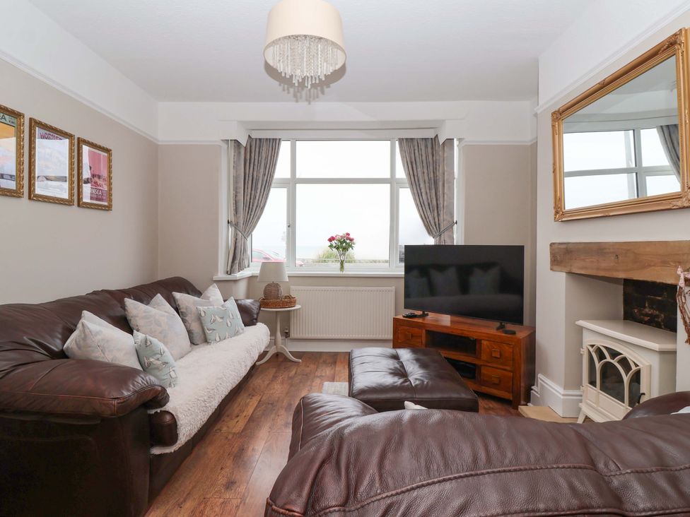 A living room with a sofa and television at Sea View House in Hornsea