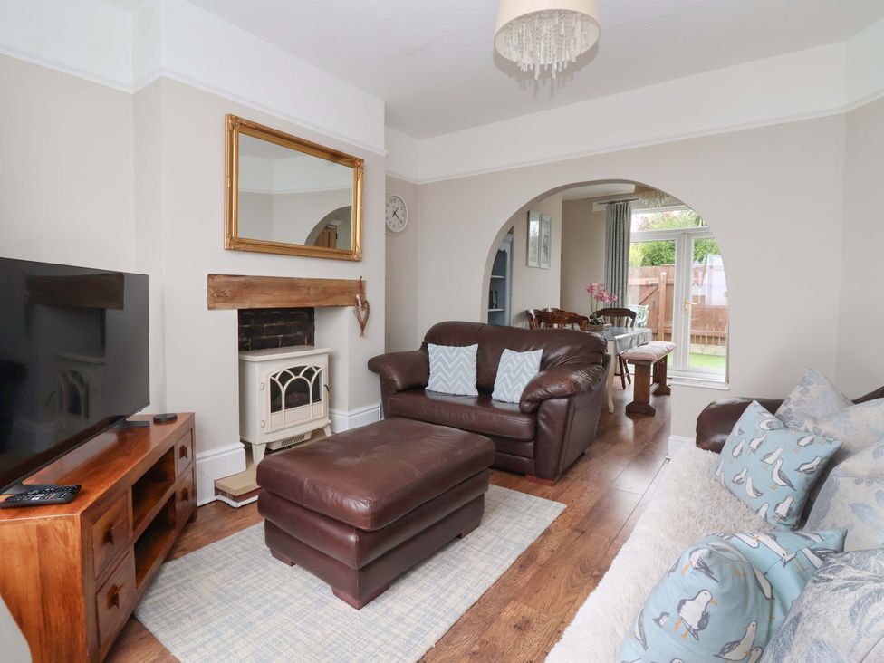 A living room with a television and fireplace at Sea View House in Hornsea