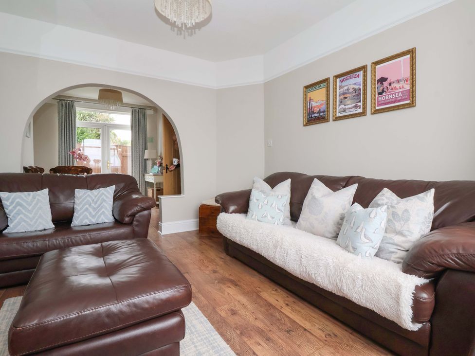 A living room with a sofa and armchair at Sea View House in Hornsea