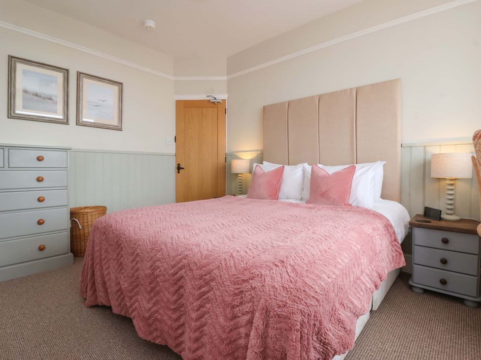 A bedroom with a bed and bedside tables at Sea View House in Hornsea