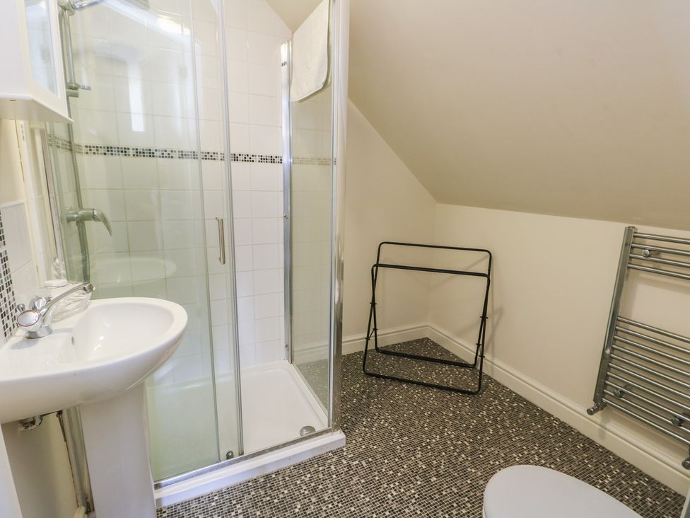 A bathroom with a shower and sink at Ty Ni in Caeathro near Caernarfon