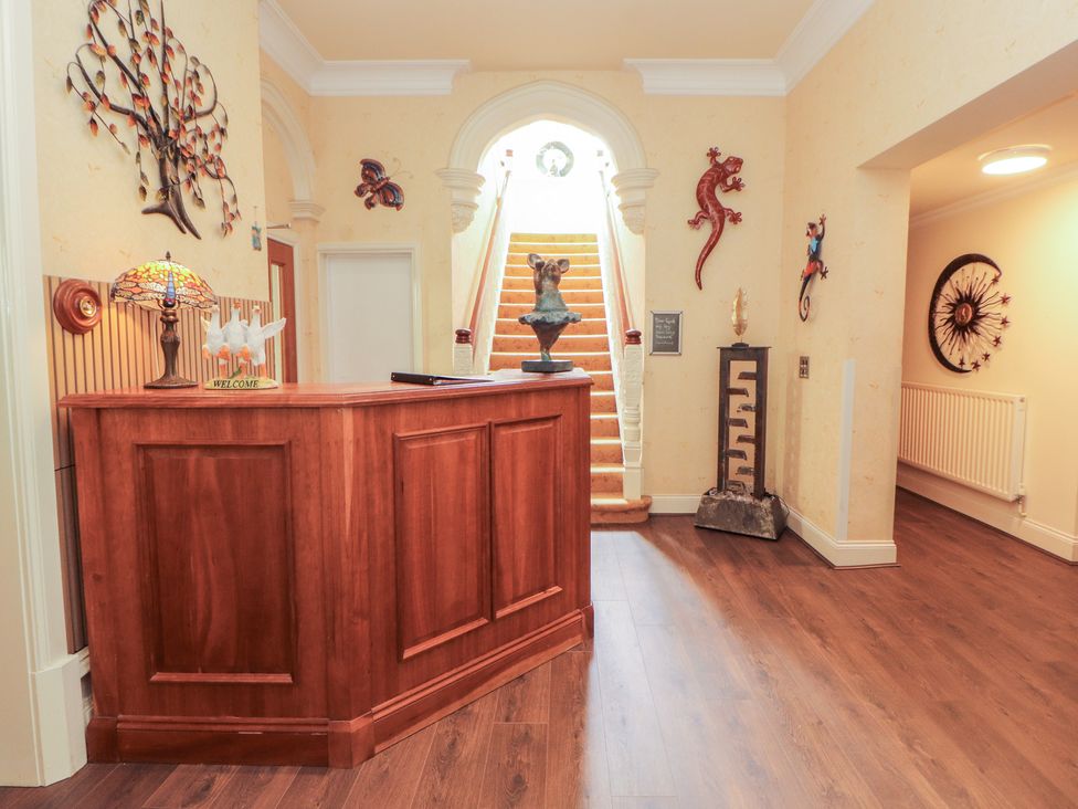 A reception area with a desk and wall decor at Eden Lodge in Bardsea
