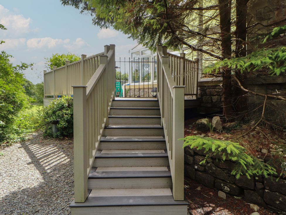 Stairs leading to a fenced area at Eden Lodge in Bardsea