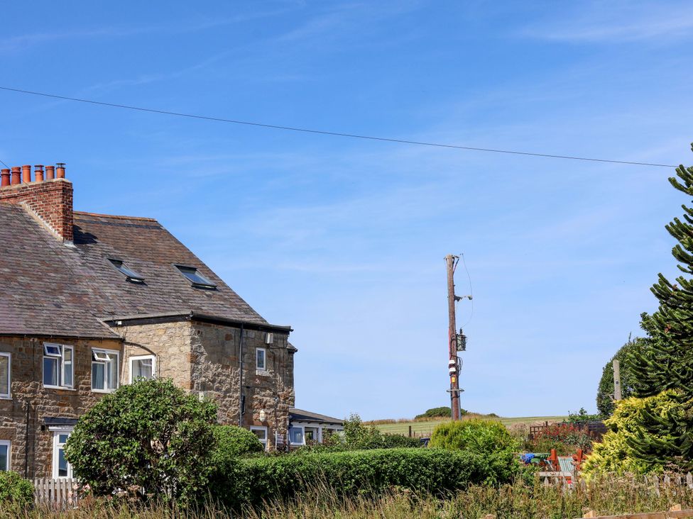 A house with a chimney and bushes at 4 Cliff Cottages Port Mulgrave near Staithes