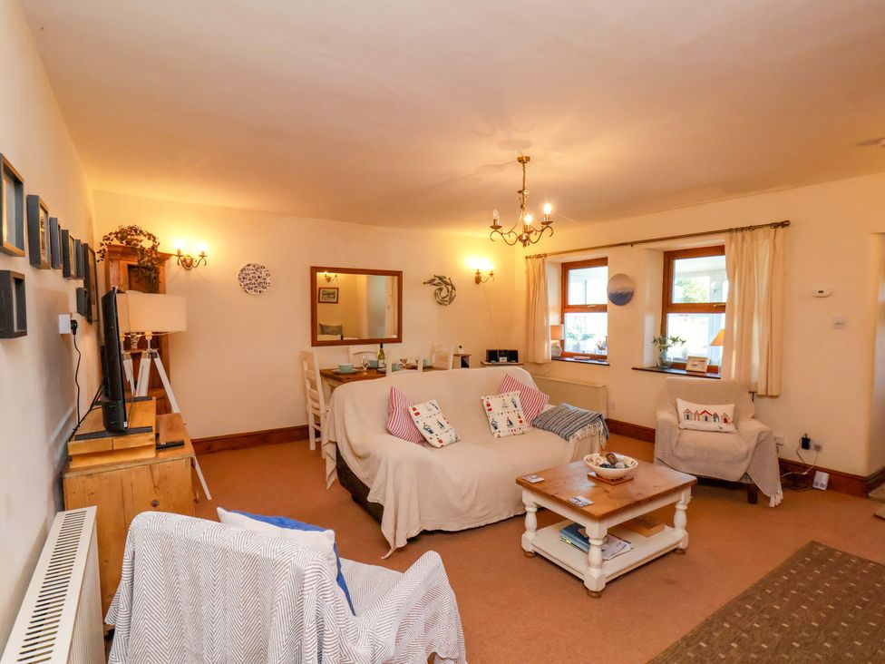 A living room with a sofa and coffee table at 4 Cliff Cottages Port Mulgrave near Staithes