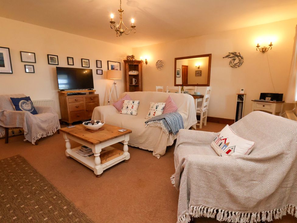 A living room with a sofa and coffee table at 4 Cliff Cottages Port Mulgrave near Staithes
