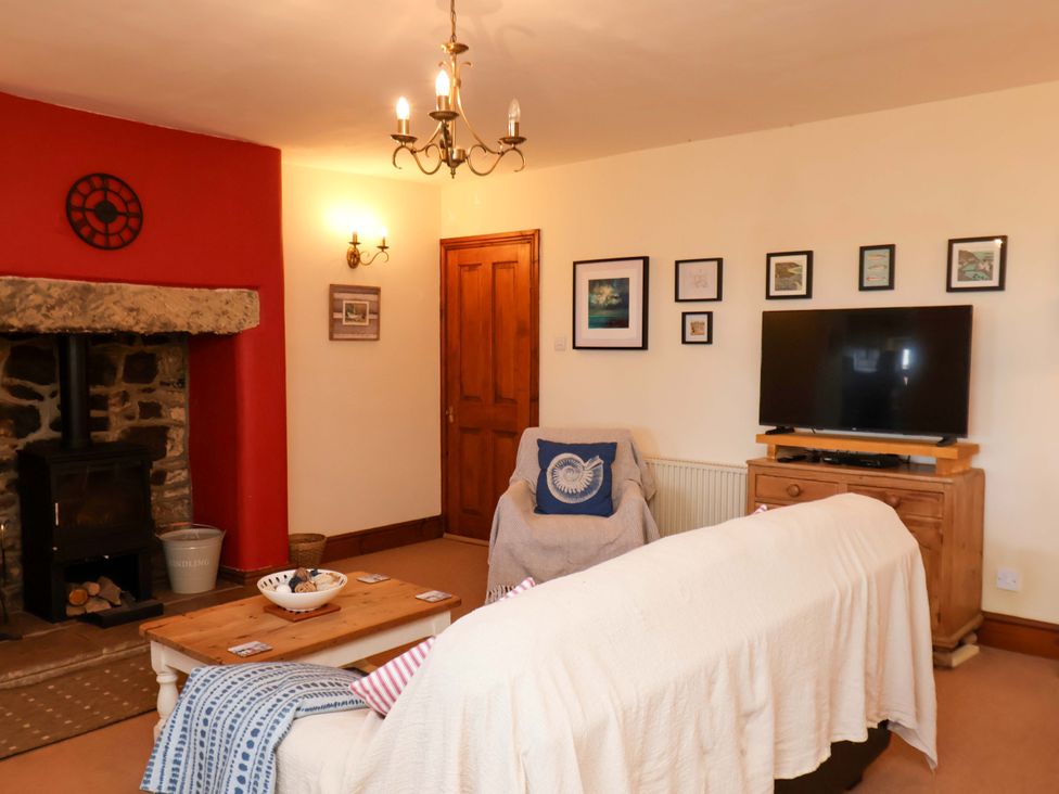 A living room with a fireplace, sofa and television at 4 Cliff Cottages in Port Mulgrave near Staithes