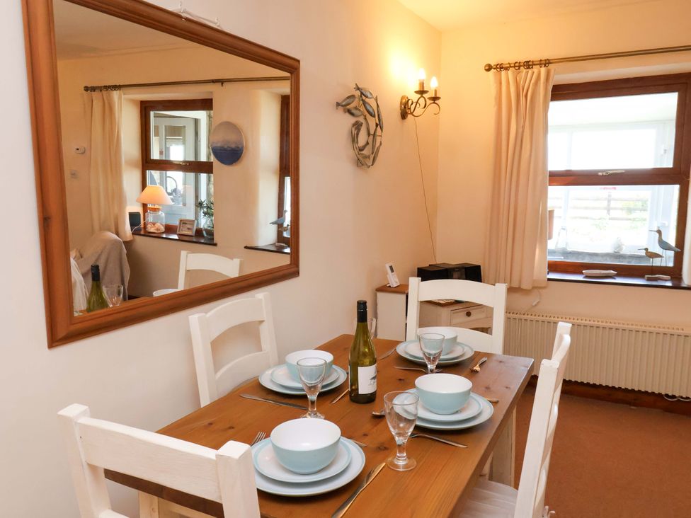 A dining room with a table set for dinner at 4 Cliff Cottages in Port Mulgrave near Staithes