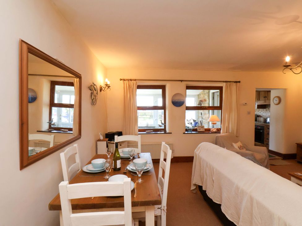 A dining room with a table and chairs at 4 Cliff Cottages Port Mulgrave near Staithes