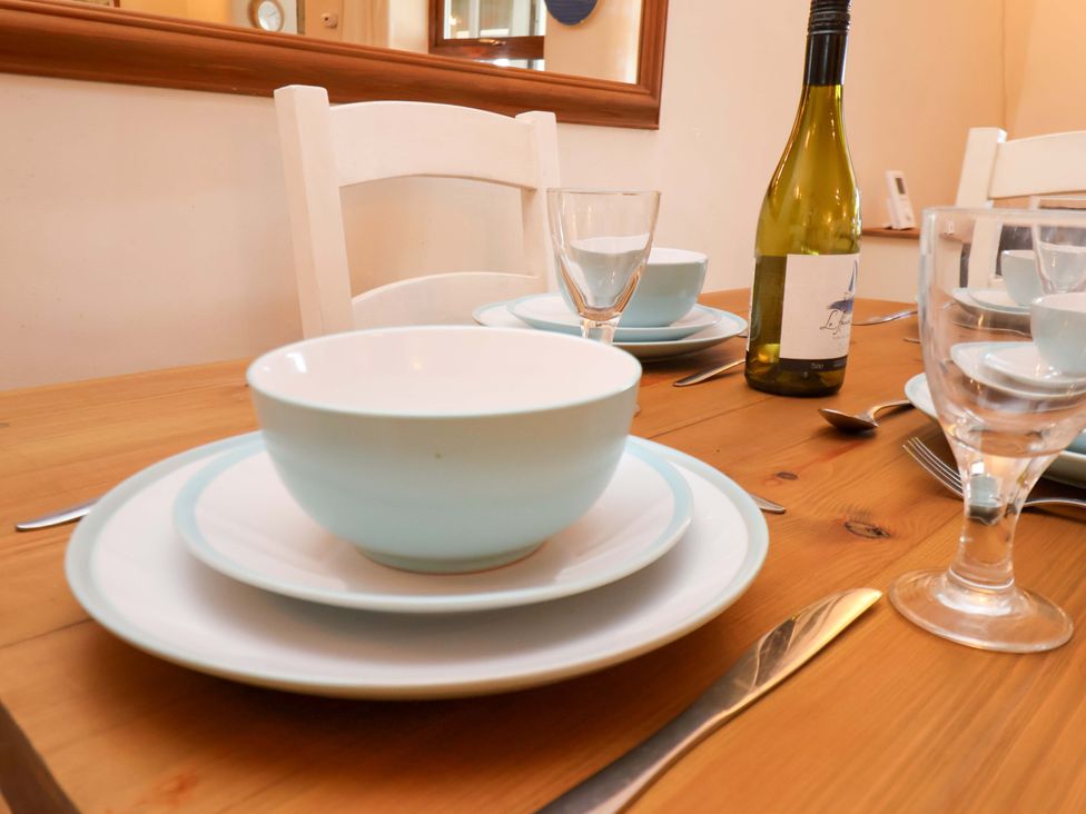 A dining table with plates and glasses at 4 Cliff Cottages Port Mulgrave near Staithes