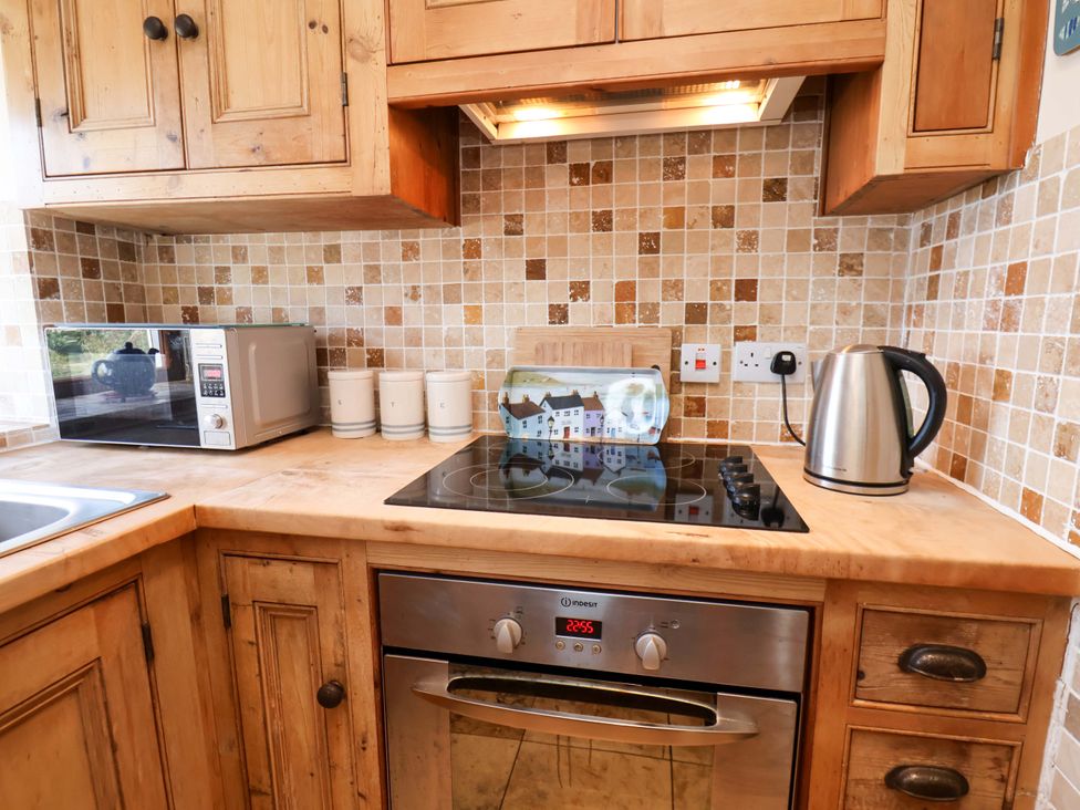 A kitchen with appliances and cabinetry at 4 Cliff Cottages Port Mulgrave near Staithes