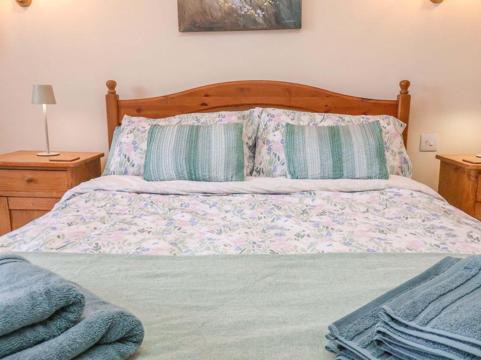 A bedroom with a bed and bedside tables at 4 Cliff Cottages Port Mulgrave near Staithes