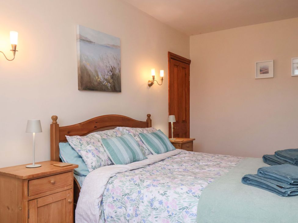 A bedroom with a bed and bedside table at 4 Cliff Cottages Port Mulgrave near Staithes