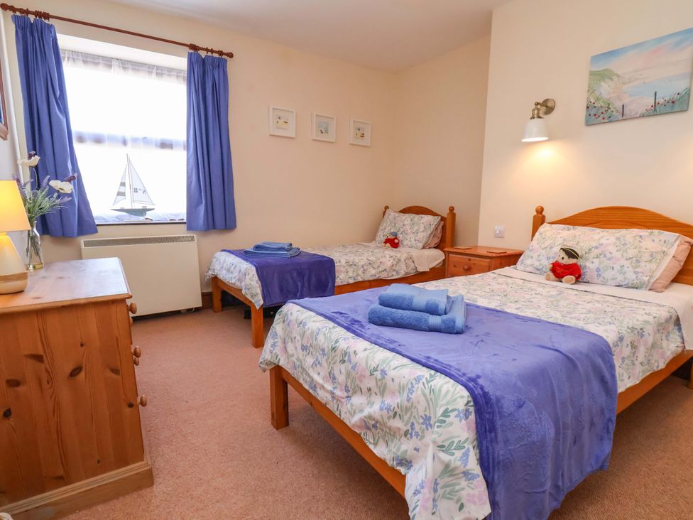 A bedroom with two beds and a dresser at 4 Cliff Cottages Port Mulgrave near Staithes